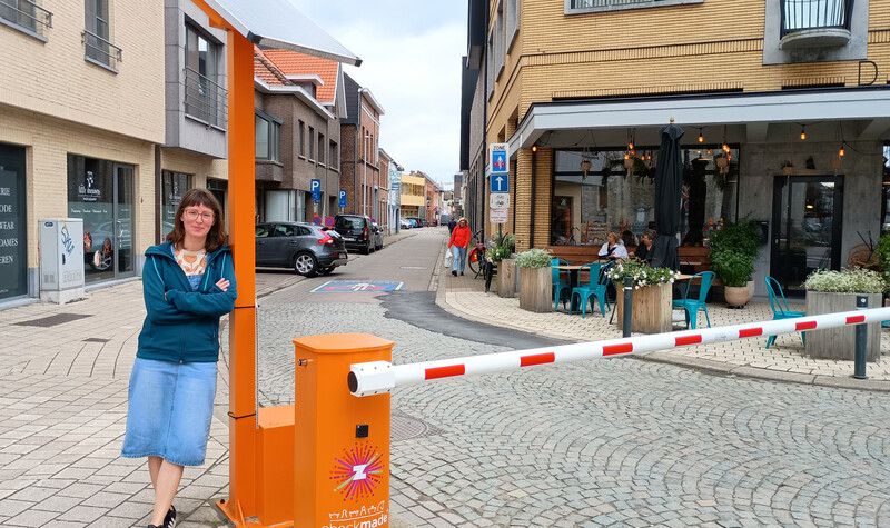 Sara Van de Voorde poseert aan de nieuwe slagboom die in de Bookmolenstraat in Zele de veilige schoolstraat afbakent.