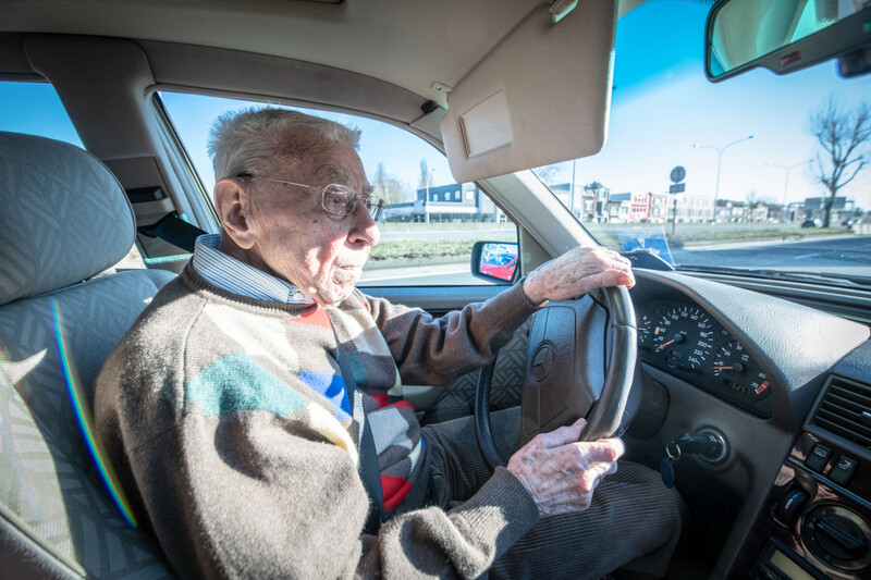 Oudere man aan het stuur van een tweedehandswagen